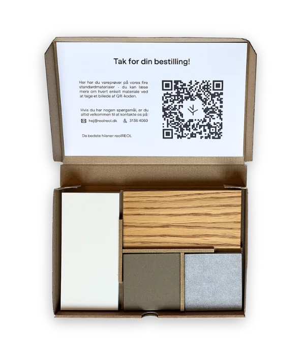 Open box containing various material samples, including wood, stone, and metal, with a printed QR code and text on the lid.